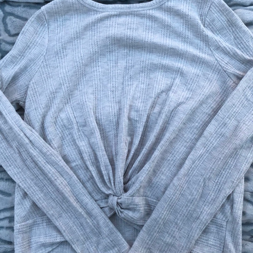 A long sleeve knotted shirt.